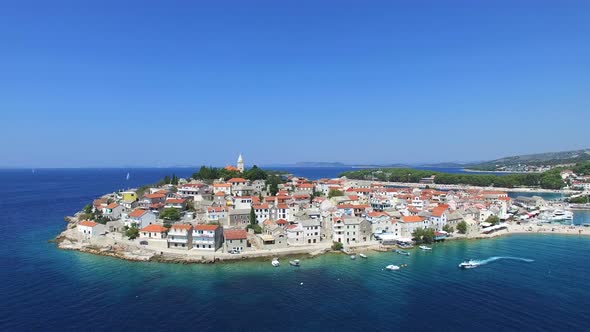 Aerial view of motorboat passing in front of Primosten, Croatia