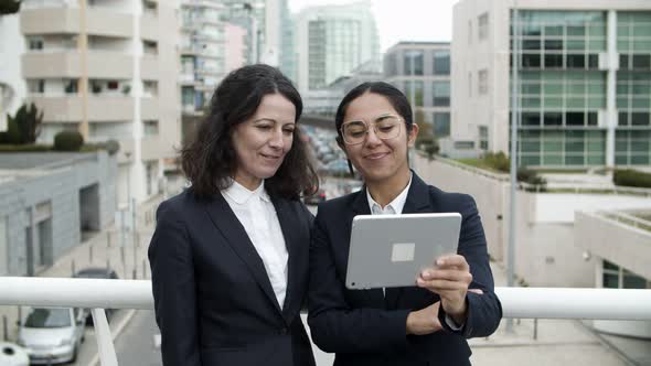 Businesswomen Having Video Chat Via Tablet Pc