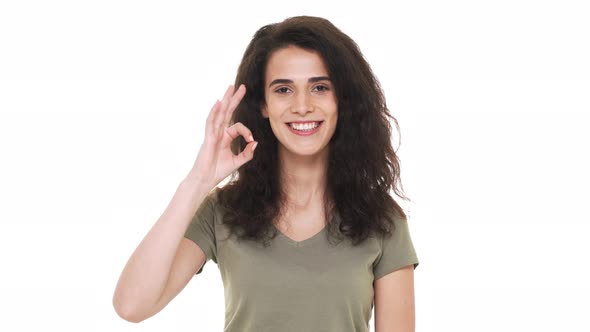 Portrait of Satisfied Hispanic Woman Wearing Basic Clothing Gesturing Ok Symbol Expessing Approval
