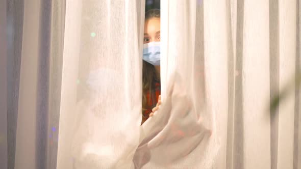 Adorable Little Girl and Boy in Covid19 Face Masks Opening Curtains Looking at Camera Smiling