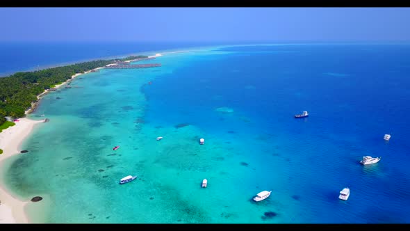 Aerial drone view scenery of relaxing coast beach lifestyle by turquoise ocean and white sandy backg