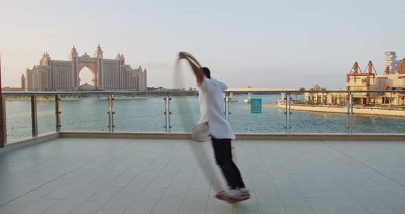 Sunset in Dubai Atlantis Hotel and the Sea Young Man Doing Wheel Gymnastics