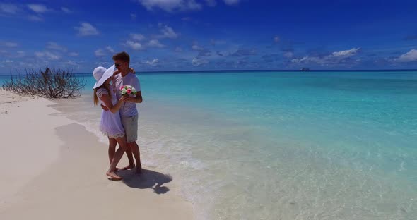 Fun people on honeymoon vacation enjoy life on beach on summer white sandy background 