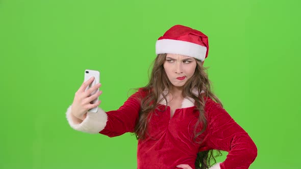 Santa Woman Makes the New Years Self with Different Emotions. Green Screen