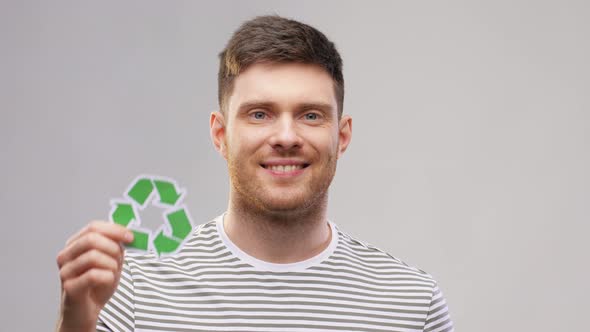 Smiling Young Man Holding Green Recycling Sign