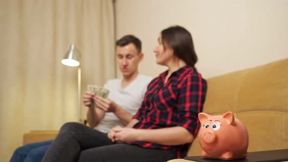 Man Woman Plan Family Budget Counting Dollars By Piggy Bank