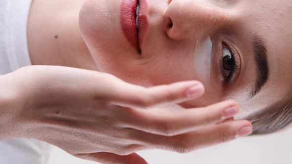 Under Eye Moisturizing Woman Applying Face Cream