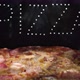 Delicious Fresh Italian  Pizza On A Black Background With The Effect Of Light Inscription Pizza - VideoHive Item for Sale