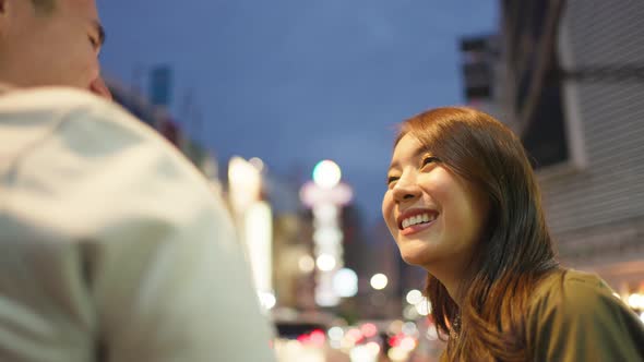 Asian active young couple travel in city for honeymoon trip at night.