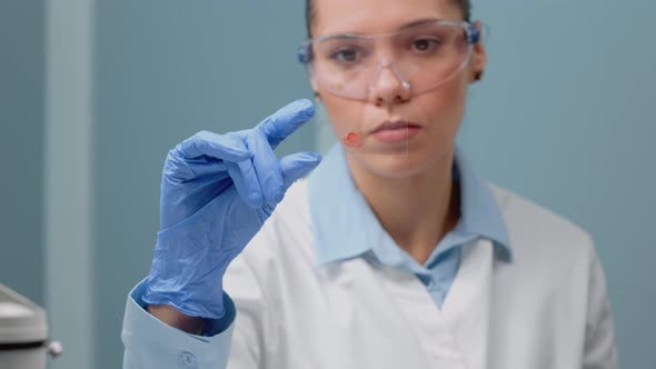 Close Up of Biology Doctor Looking at Blood Test