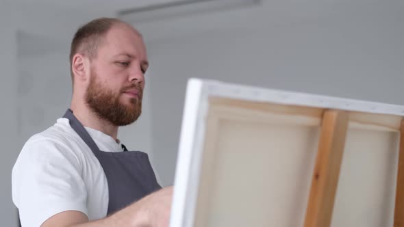 Young Artist Working in Front of a Canvas in the Studio Painting a Picture Happy Modern Artist