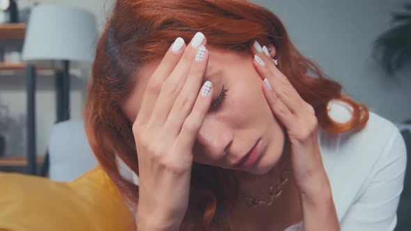 Sick Tired Exhausted Redhead Young Woman Coping with Headache Migraine at Home