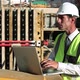 Mature Man Using Laptop on Construction Site - VideoHive Item for Sale