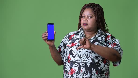 Overweight Beautiful African Woman Against Green Background