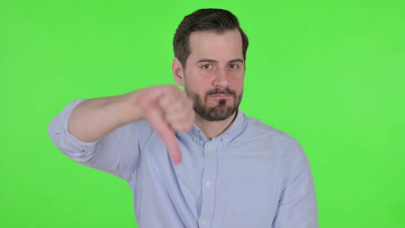 Portrait of Man Showing Thumbs Down Gesture Green Screen