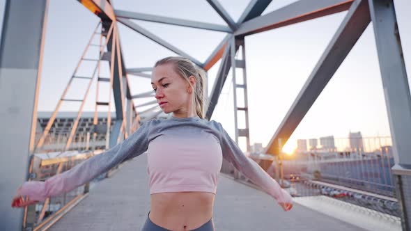 Attractive Young Female Do Stretching Gymnastic Exercises Standing on Bridge