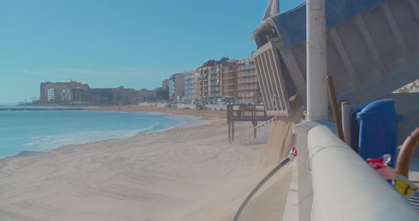 Truck Unloads Sand on the Beach.