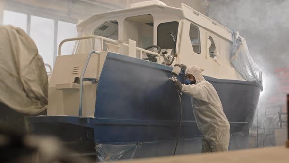 Workman Using Airbrush on Boat
