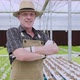 Caucasian male business owner observes about growing organic arugula on hydroponics farm - VideoHive Item for Sale