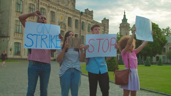 Young People Protesting Holding Placards with Inscriptions Outdoors