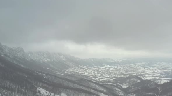 Snow and heavy fog on top of mountain Velik Krs 4K aerial video