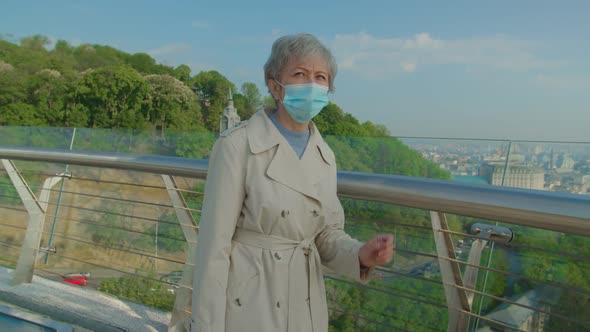 Elderly Vaccinated Woman Putting Off Mask to Breath Fresh Air