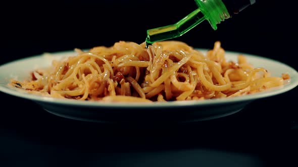 Man Seasoning Pasta With Olive Oil. Cook Garnishing Spaghetti In Plate. Macaroni Pasta With Cheese.