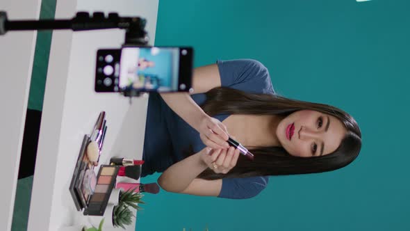 Vertical Video Content Creator Doing Product Review on Camera in Studio