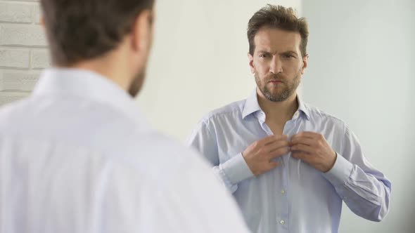 Sleepy Man Wearing Shirt, Preparing for Work in Morning, Unhappy With Appearance