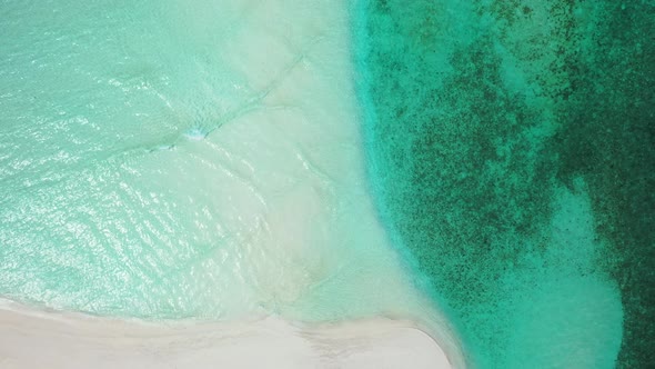 Natural above island view of a white paradise beach and aqua blue water background in colorful 