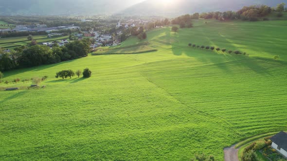 Aerial Landscape View of Ideal Green Fields in Liechtenstein Alps at Sunset