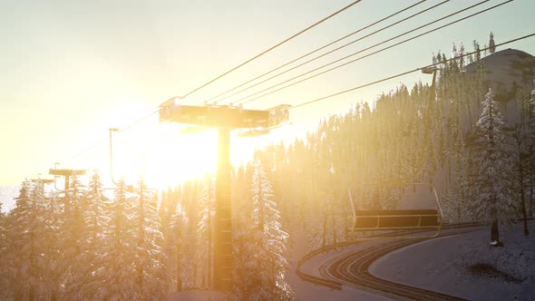 Empty Ski Lift. Chairlift Silhouette on High Mountain Over the Forest at Sunset alt
