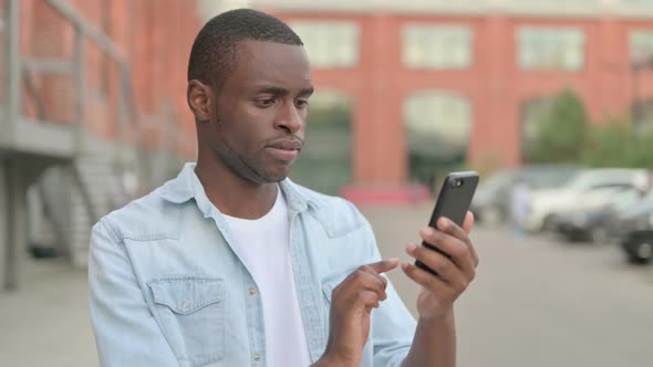 Outdoor African Man Using Smartphone