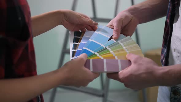 Human Hands Choosing Color From Color Palette