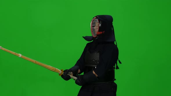 Masculine Kendo Warrior Practicing Martial Art with the Bamboo Bokken on Green Screen. CLose Up