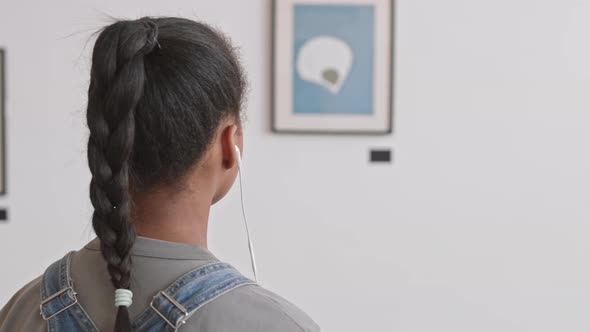 Girl Using Audio Guide in Gallery