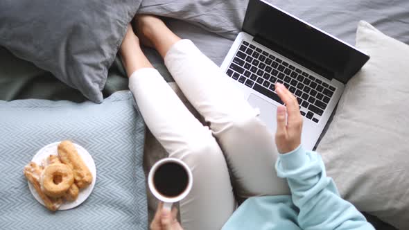 Trendy Top View Of Woman Legs, Laptop And Coffee Cup