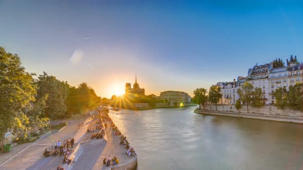 Rear View of Notre Dame De Paris Cathedral at Sunset with Sun in the Frame Timelapse