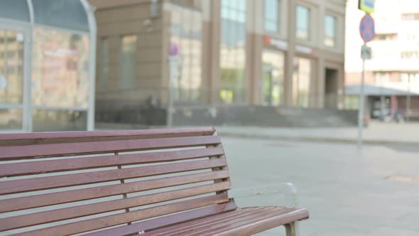 Man Coming Sitting on Bench and Opening Laptop