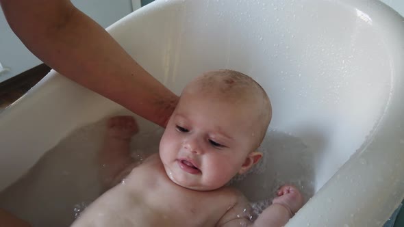 Mother take a bath for his newborn baby. Baby bath time