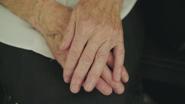 Close View of Unrecognizable Tired Grandmother's Folded Hands