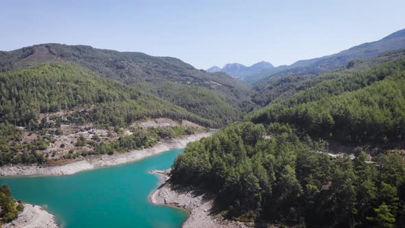 mountain river with green trees stones at bank 4k aerial bird eye view above