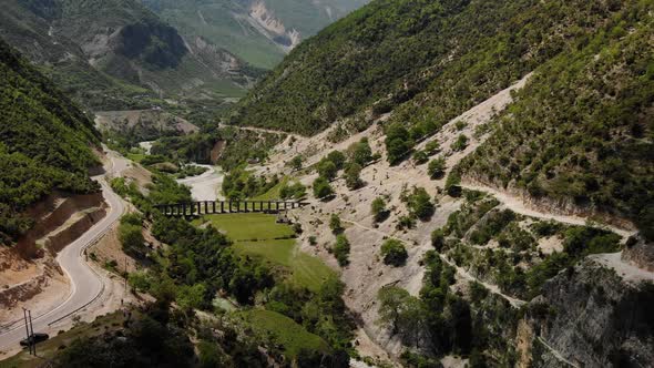 Aerial Drone Footage View Flight Over Mountain with Forests Fields and River