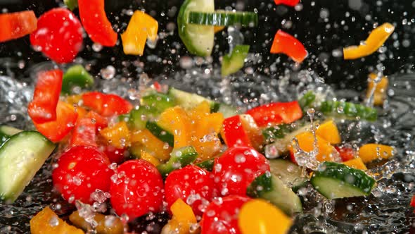 Super Slow Motion Shot of Colorful Vegetables Falling Into Water on Black Background at 1000Fps