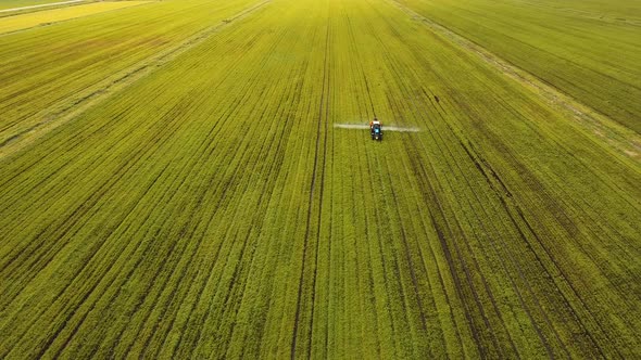 Tractor is Spraying Fertilizers Field