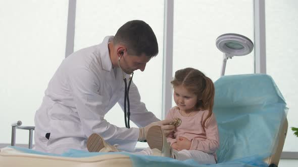 The Doctor Listens to the Lungs of the Child With a Stethoscope Speaks Caringly