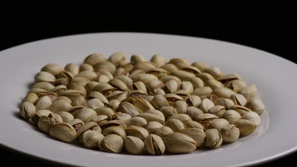 Cinematic, rotating shot of pistachios on a white surface - PISTACHIOS 020