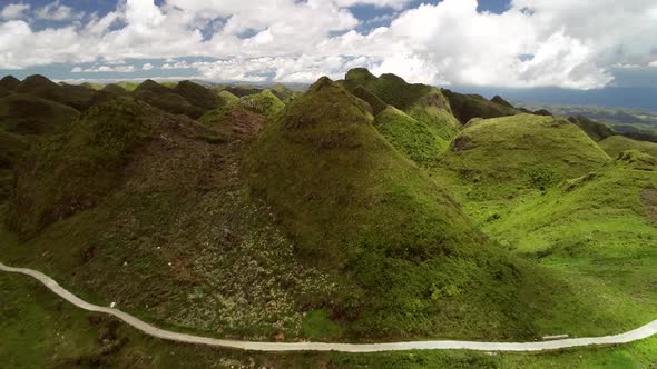 Aerial view of Chocolate hills and cloudy sky in Badian, Philippines.