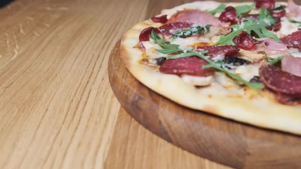 Appetizing Pizza on a Wooden Board in a Restaurant