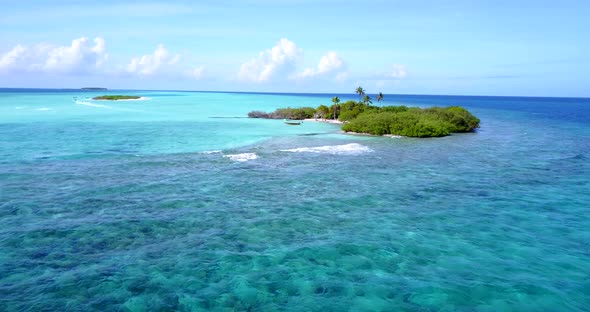 Tropical flying copy space shot of a white sand paradise beach and aqua turquoise water background i